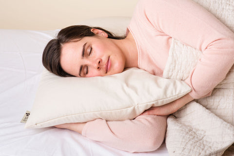 Woman on comfycomfy curved buckwheat hull pillow sleeping supported