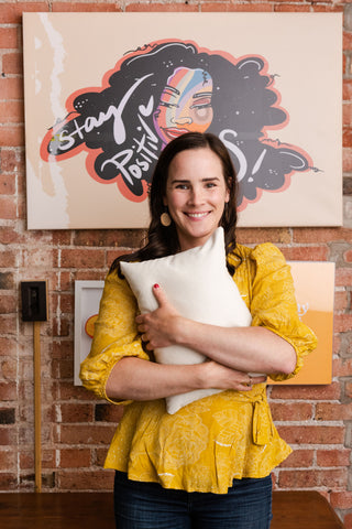 Woman holding comfycomfy mini buckwheat hull pillow